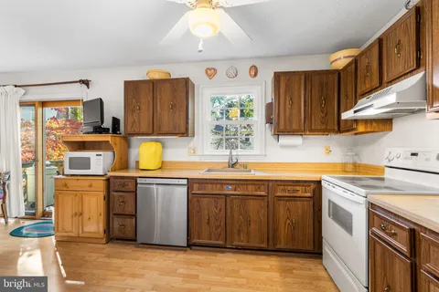 a kitchen with stainless steel appliances granite countertop a sink and cabinets