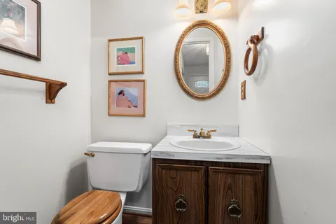 a bathroom with a toilet a sink and a mirror