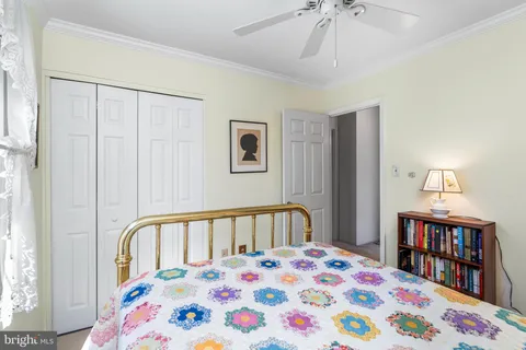 a bedroom with a bed and a book shelf