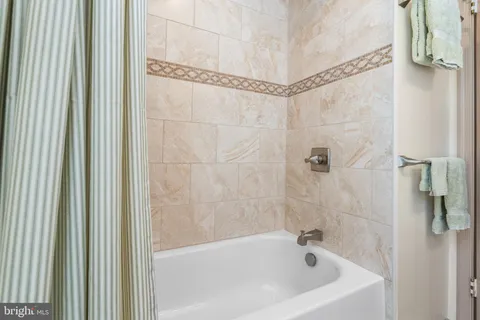 a white bath tub with a shower