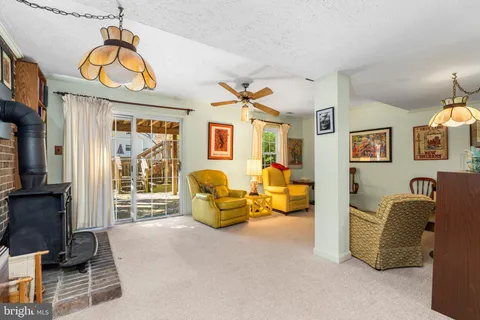 a living room with furniture gym equipment and a fireplace