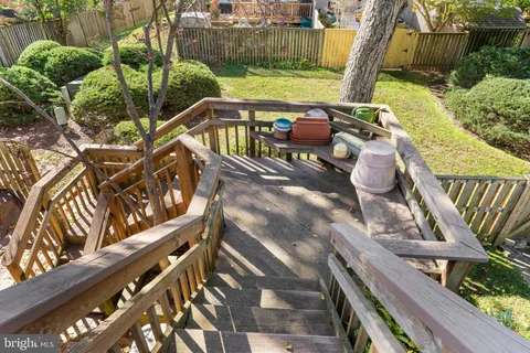 a view of an outdoor sitting area with wooden fence