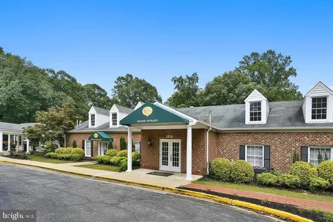 a view of a swimming pool with an outdoor space and seating area