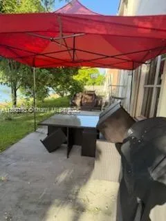 a patio with table and chairs