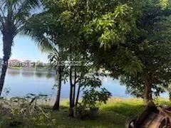 a living room with couches and a dining table with wooden floor