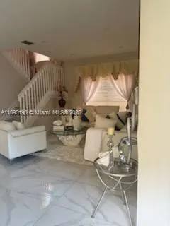 a white toilet sitting next to a bathroom sink and vanity