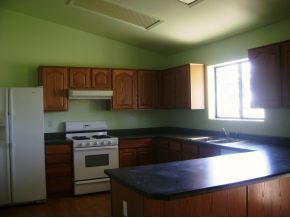 1095 Saddle Road Paulden, AZ 86334 - Photo 2 of 12 a kitchen with granite countertop a stove a sink and a microwave