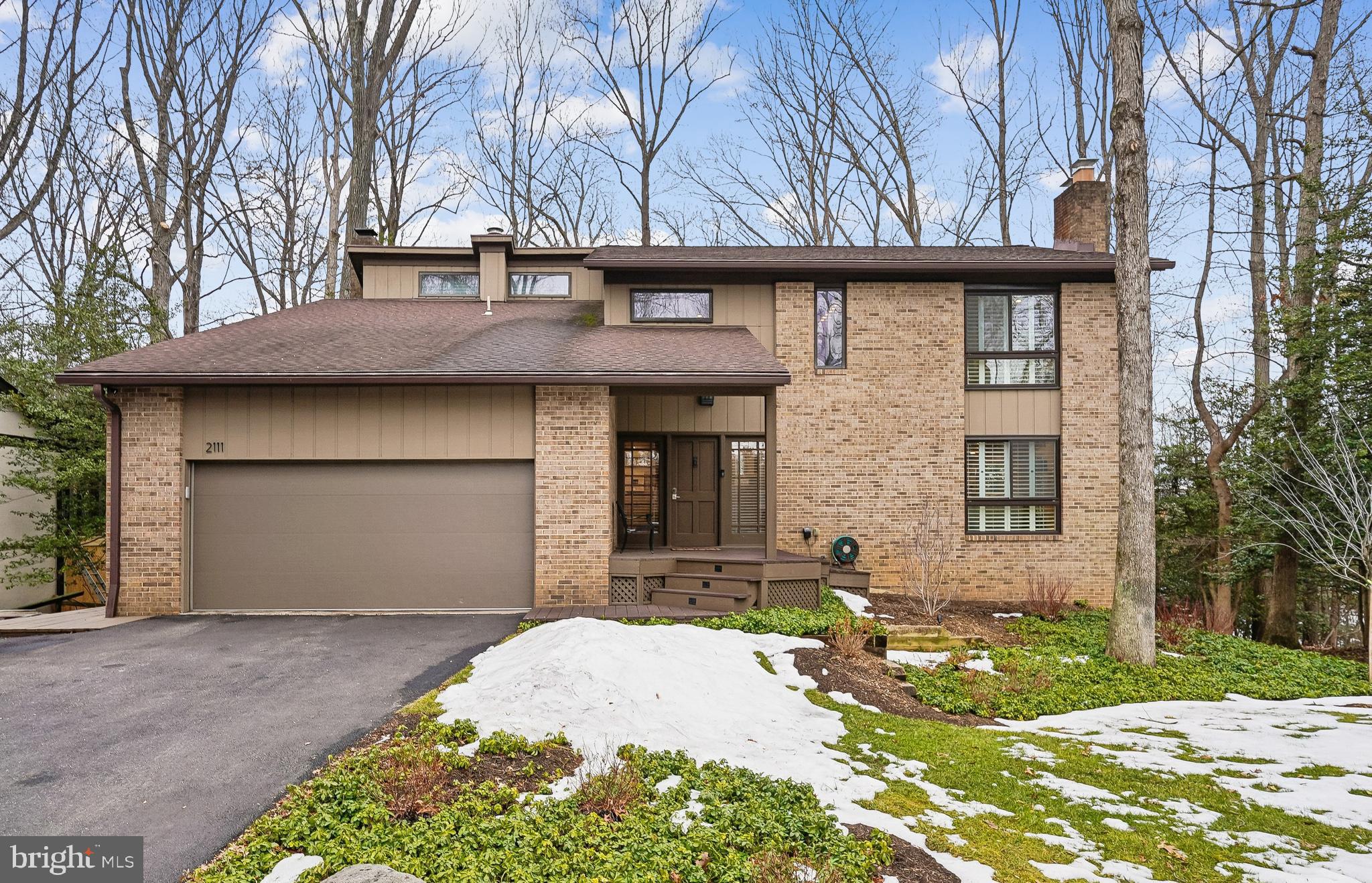 2111 Lirio Court Reston, VA 20191 - Photo 1 of 40 a front view of a house with a garden