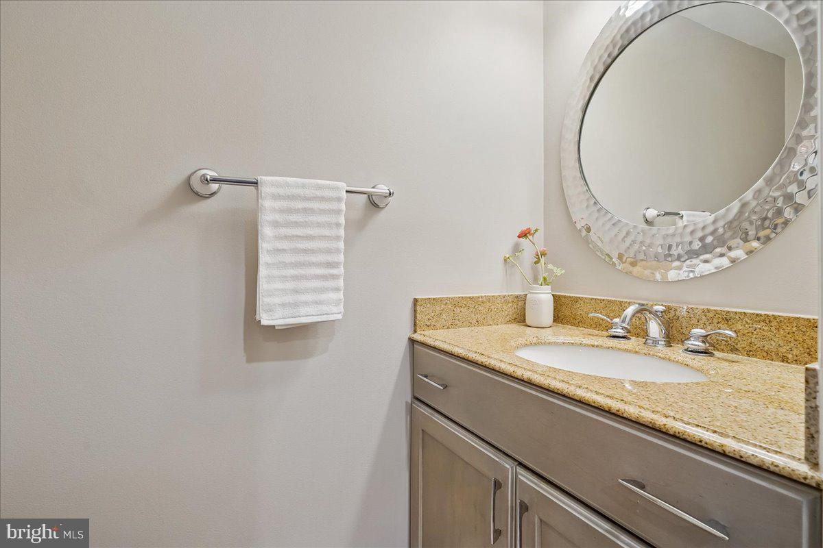 2111 Lirio Court Reston, VA 20191 - Photo 12 of 40 a bathroom with a granite countertop sink and a mirror