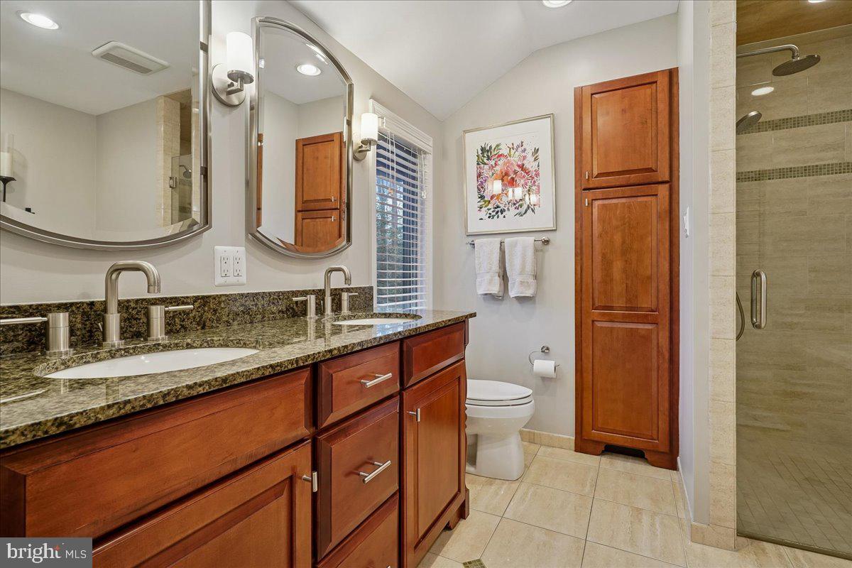 2111 Lirio Court Reston, VA 20191 - Photo 18 of 40 a bathroom with a double vanity sink toilet and mirror