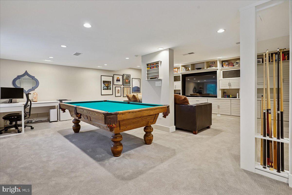 2111 Lirio Court Reston, VA 20191 - Photo 25 of 40 a living room with furniture a flat screen tv and a table