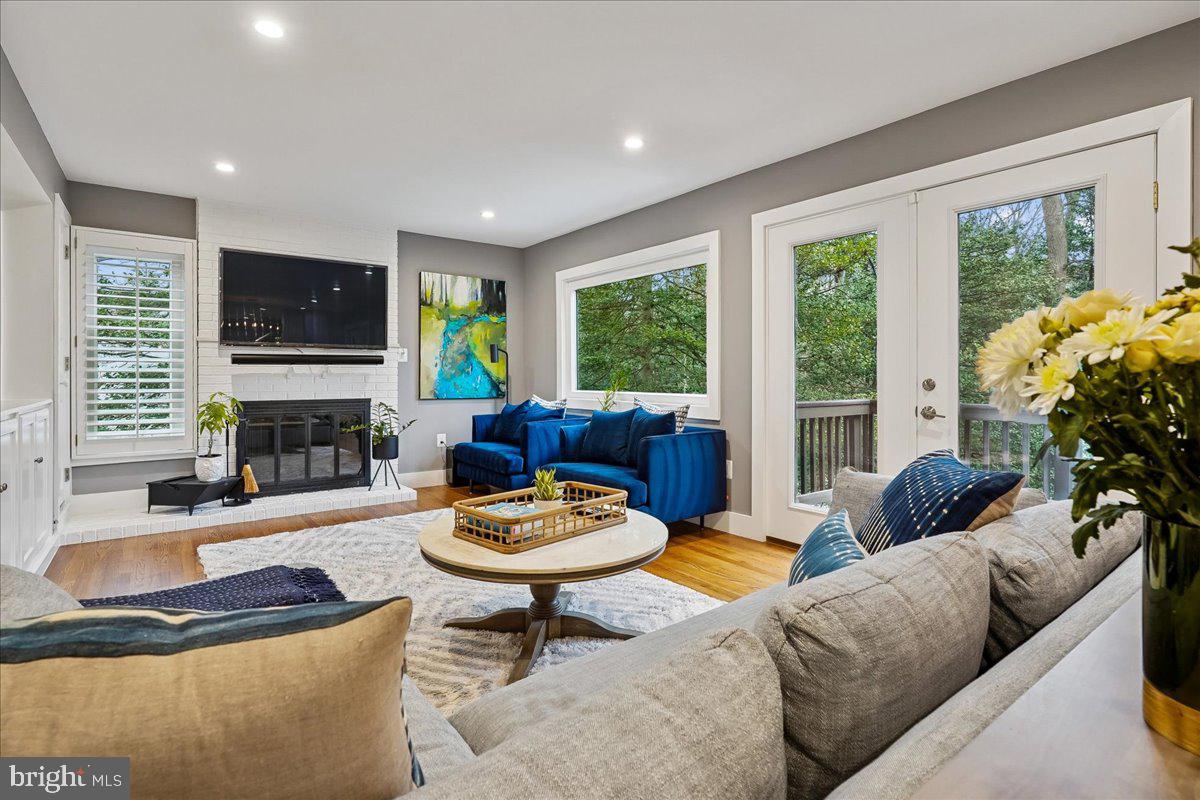 2111 Lirio Court Reston, VA 20191 - Photo 6 of 40 a living room with fireplace furniture and a flat screen tv