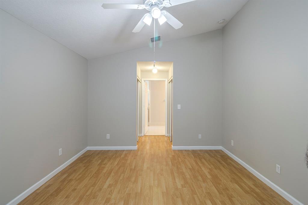 1875 Barnstable Road Wellington, FL 33414 - Photo 12 of 29 a view of an empty room with wooden floor and a window