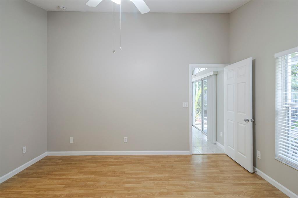 1875 Barnstable Road Wellington, FL 33414 - Photo 13 of 29 a view of an empty room with window and wooden floor