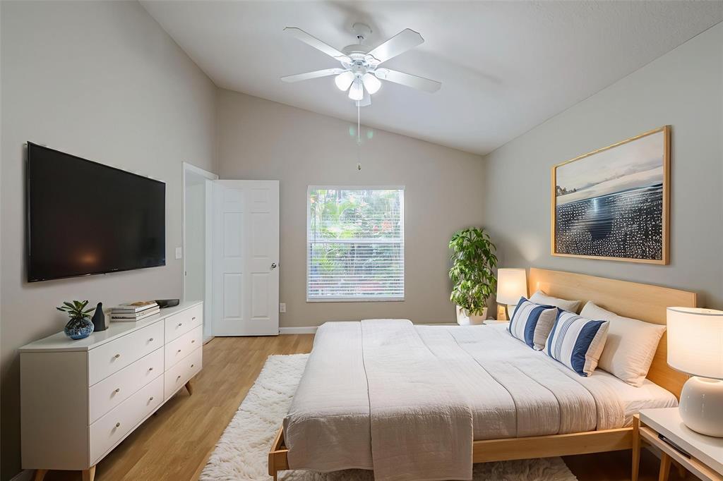 1875 Barnstable Road Wellington, FL 33414 - Photo 14 of 29 a bedroom with a large bed and a flat screen tv