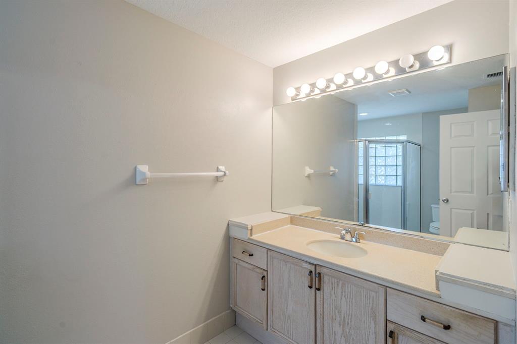 1875 Barnstable Road Wellington, FL 33414 - Photo 16 of 29 a bathroom with a sink and a mirror