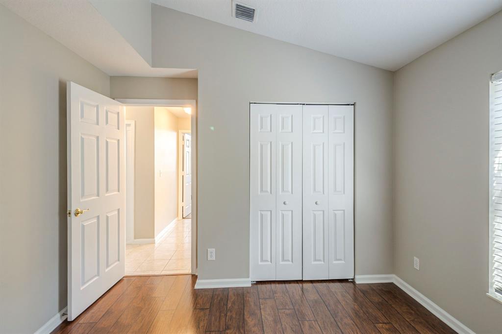 1875 Barnstable Road Wellington, FL 33414 - Photo 19 of 29 an empty room with wooden floor and windows