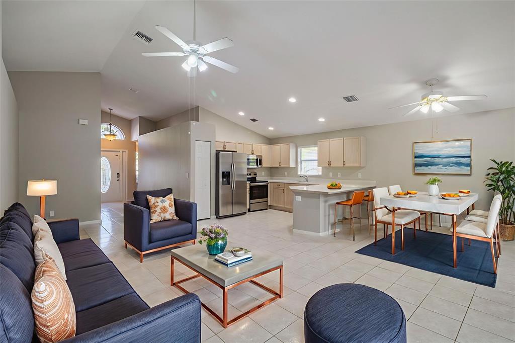 1875 Barnstable Road Wellington, FL 33414 - Photo 2 of 29 a living room with lots of furniture kitchen view and a chandelier