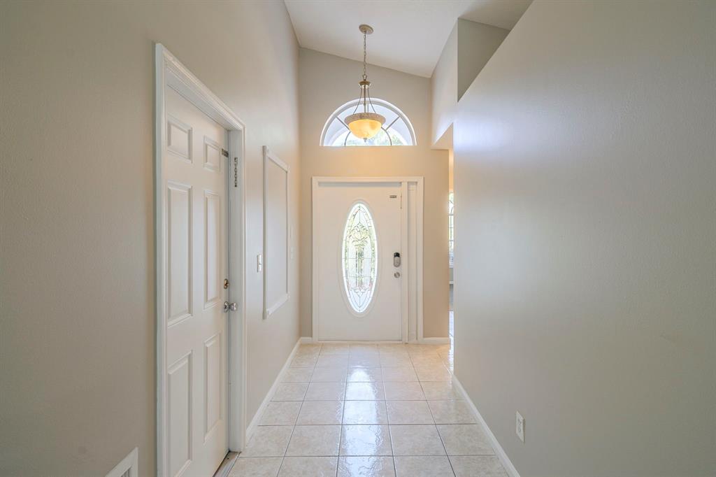1875 Barnstable Road Wellington, FL 33414 - Photo 6 of 29 a view of a hallway with wooden door