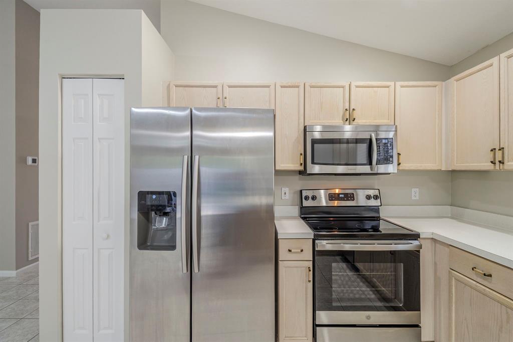 1875 Barnstable Road Wellington, FL 33414 - Photo 9 of 29 a kitchen with stainless steel appliances granite countertop a refrigerator a stove and white cabinets