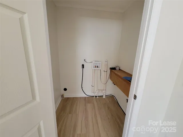 a view of an entryway with wooden floor