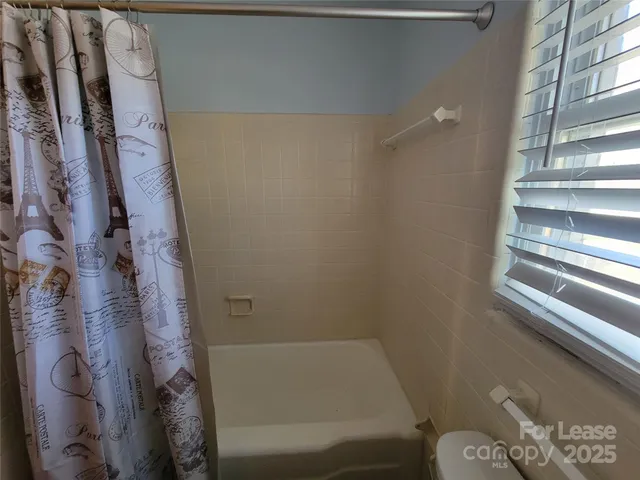 a bathroom with a bathtub and shower