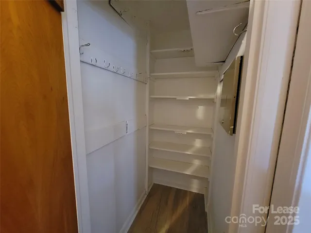 a view of walk in closet with empty racks