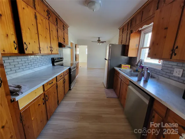 a kitchen with sink stove and cabinets