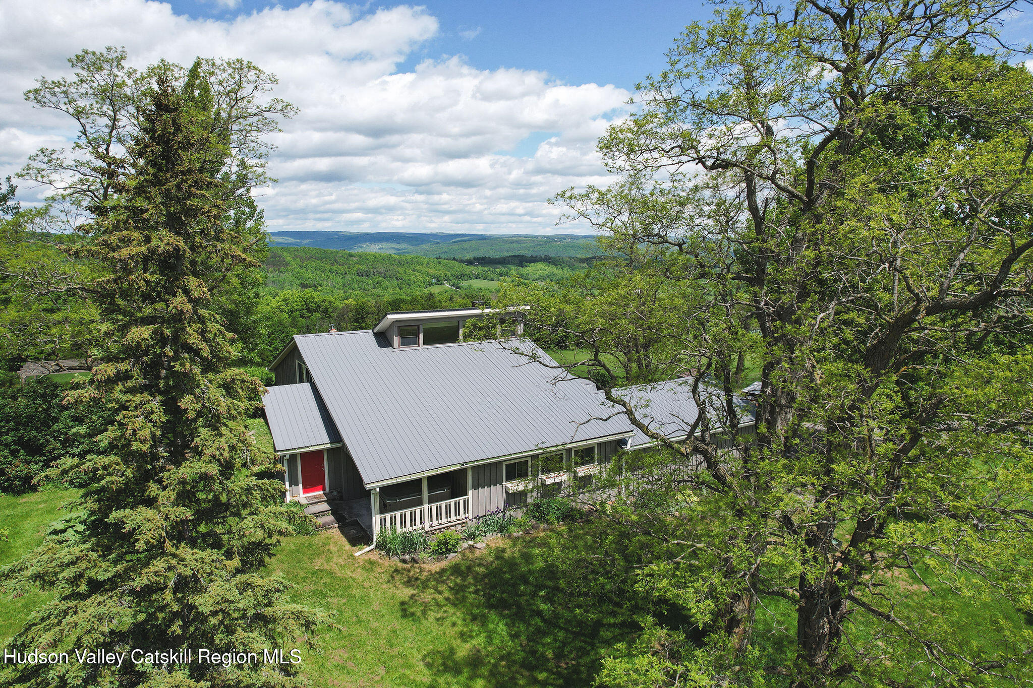 an aerial view of a house with yard and outdoor seating