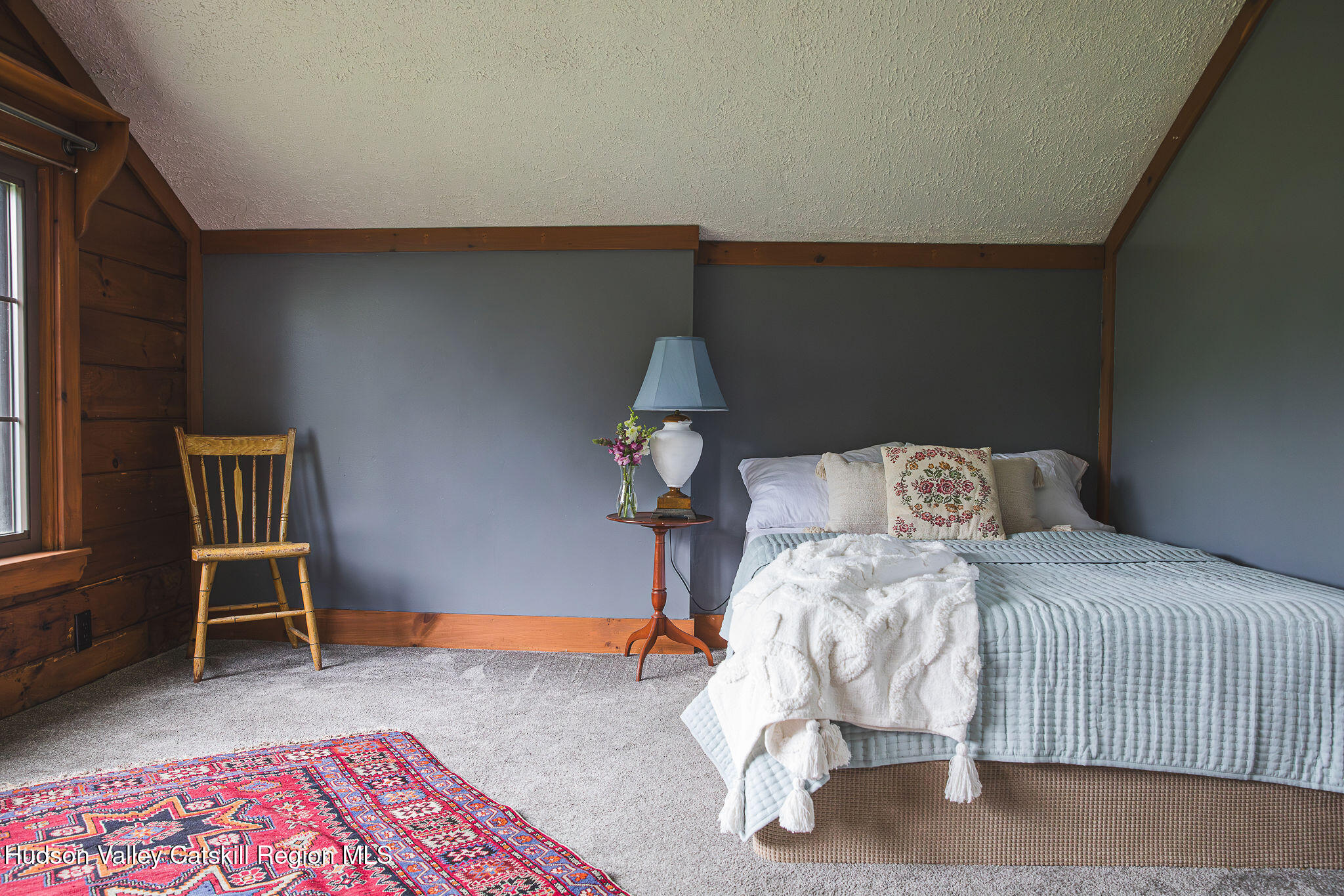 506 Cunningham Road Durham, NY 12422 - Photo 28 of 37 a bedroom with a bed and a chair