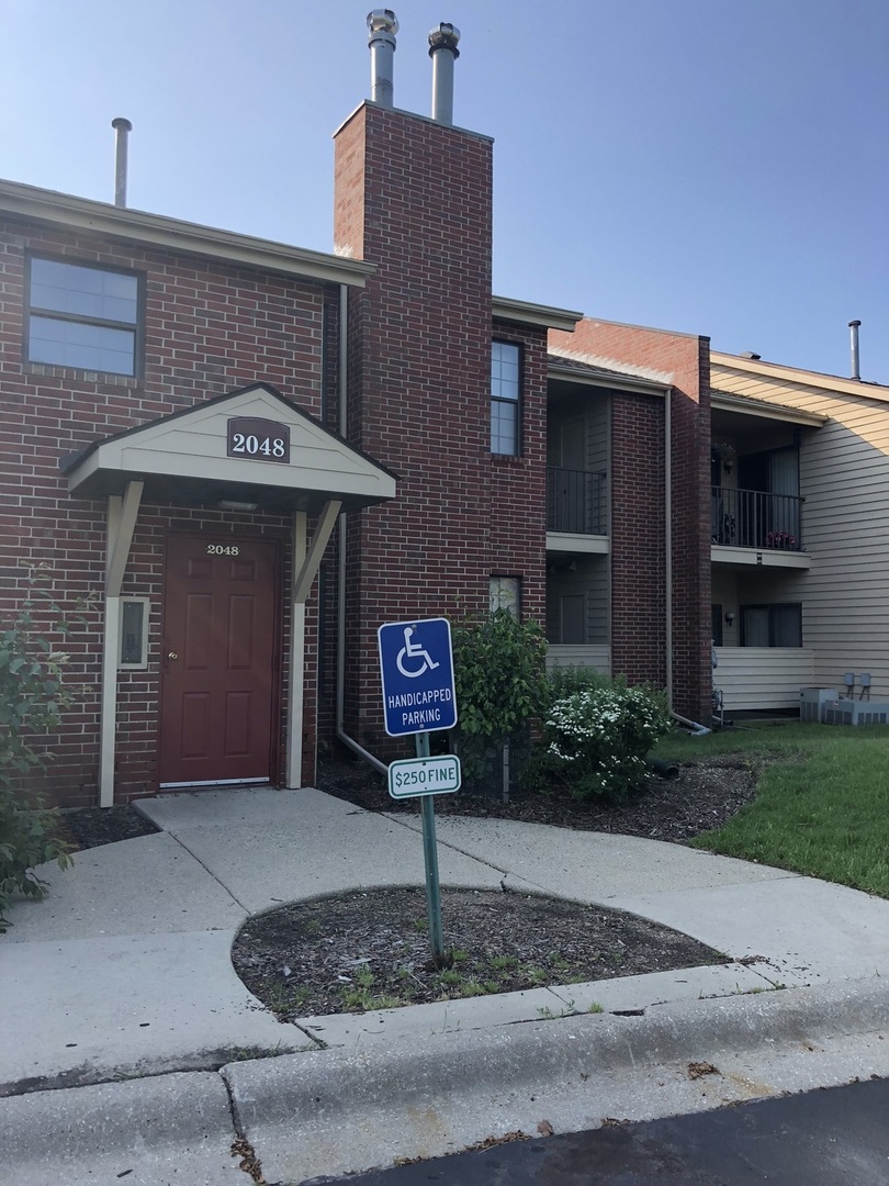 2048 North Rand Road, Unit 202 Palatine, IL 60074 - Photo 2 of 12 a front view of a house with garden