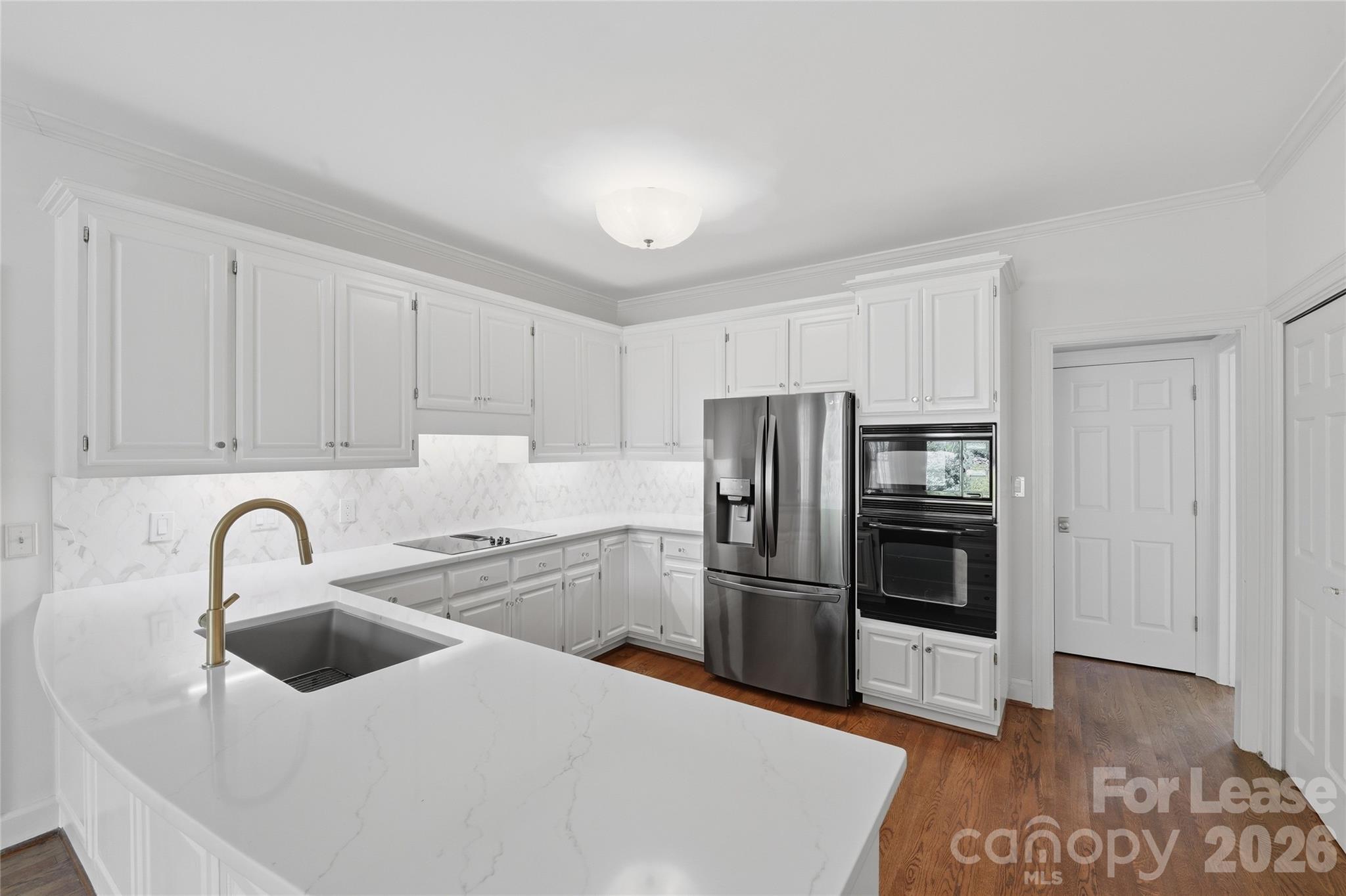 5906 Sharon Hills Road Charlotte, NC 28210 - Photo 4 of 30 a kitchen with refrigerator and cabinets