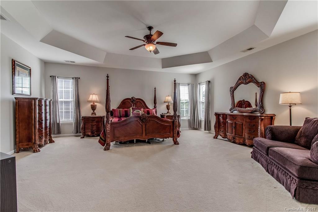 634 Panthers Way Fort Mill, SC 29708 - Photo 14 of 24 a bed room with furniture and a ceiling fan