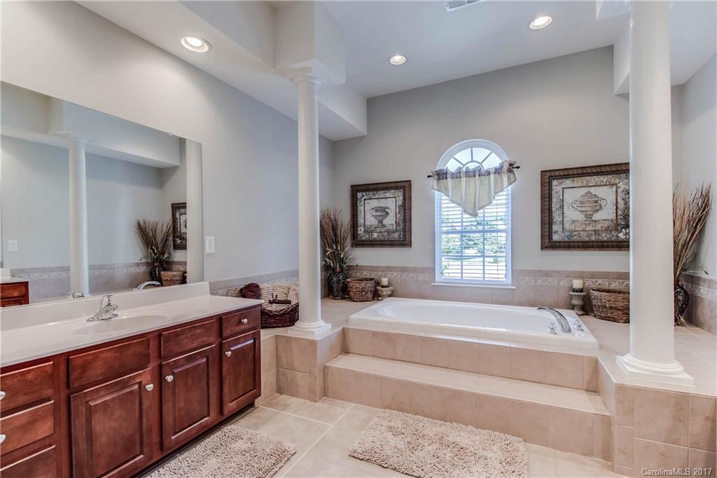 634 Panthers Way Fort Mill, SC 29708 - Photo 16 of 24 a spacious bedroom with a large bed and a large mirror