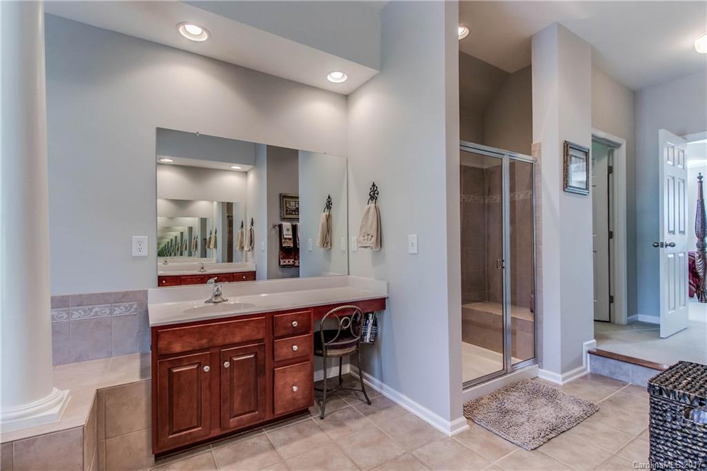 634 Panthers Way Fort Mill, SC 29708 - Photo 17 of 24 a spacious bathroom with a granite countertop sink mirror and shower