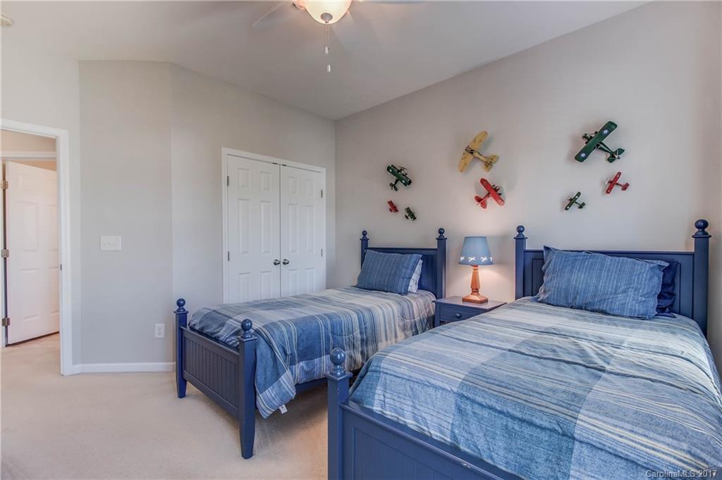 634 Panthers Way Fort Mill, SC 29708 - Photo 19 of 24 a bedroom with two beds and a potted plant on the dresser