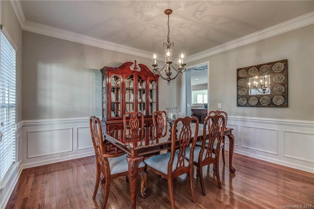 634 Panthers Way Fort Mill, SC 29708 - Photo 3 of 24 a view of a dining room with furniture wooden floor and chandelier