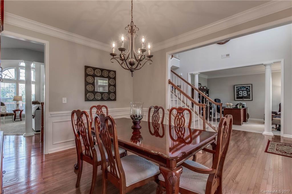 634 Panthers Way Fort Mill, SC 29708 - Photo 4 of 24 a view of a dining room with furniture wooden floor and chandelier