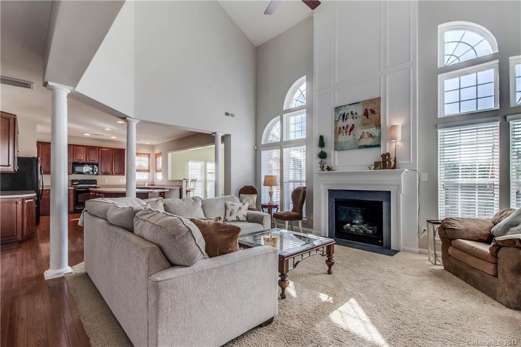 634 Panthers Way Fort Mill, SC 29708 - Photo 7 of 24 a living room with furniture a fireplace and a large window