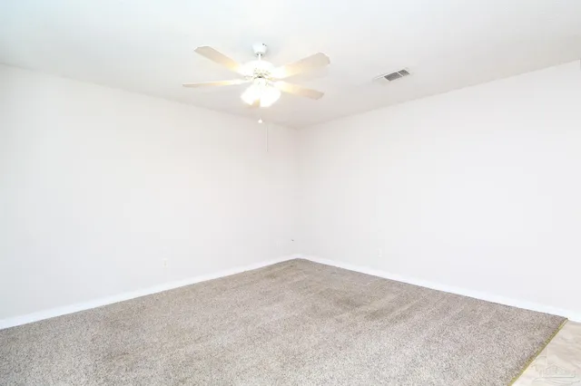 an empty room with a fan