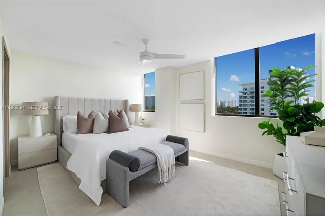 a bedroom with a large bed and a chandelier