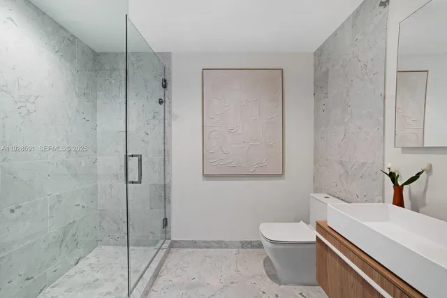 a living room with furniture kitchen view and a large window