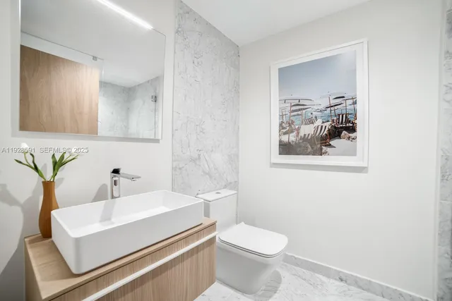 a bathroom with a sink toilet and mirror