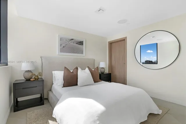 a room with furniture a potted plant and a fireplace