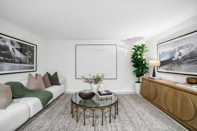 a glass vase with flowers sitting on a table with window