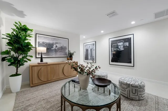 a view of a hallway with furniture and a glass door