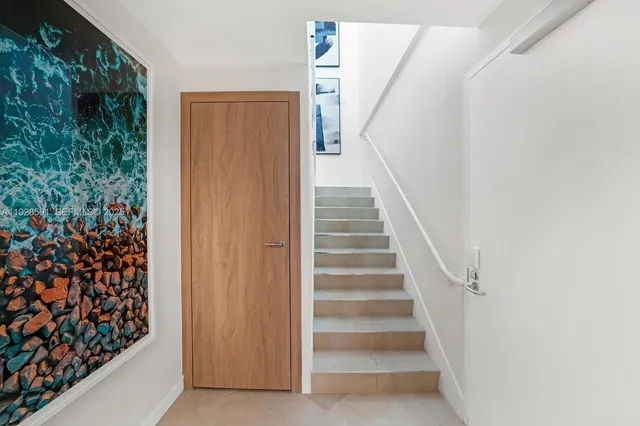 a living room with furniture a rug and a kitchen