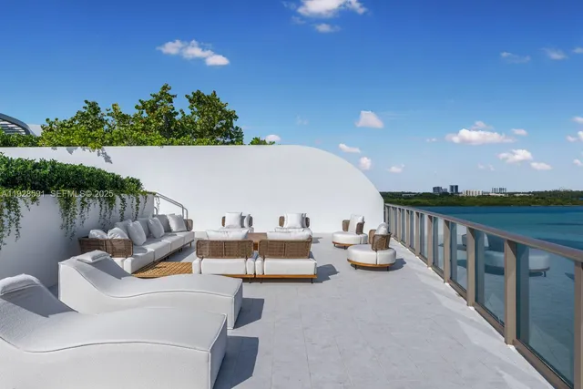 a view of a chairs and table in the back yard