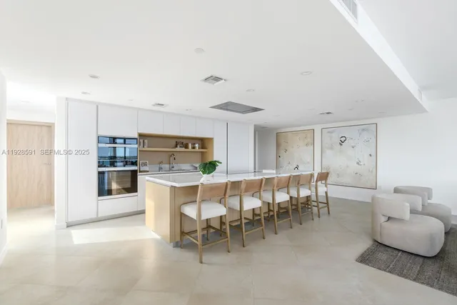 a large kitchen with a table and chairs