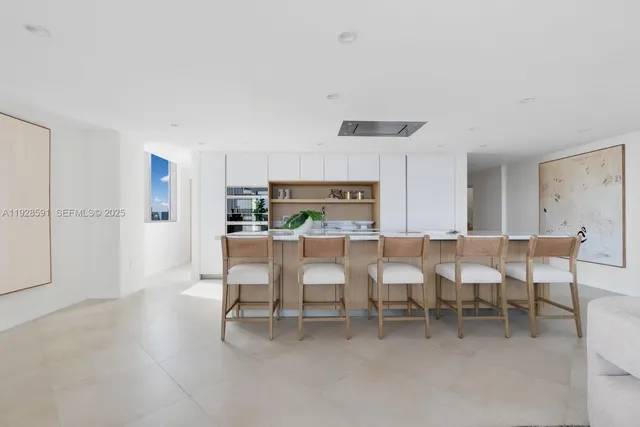 a living room with stainless steel appliances kitchen island furniture and a view of kitchen